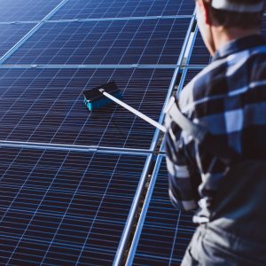 man worker in the firld by the solar panels