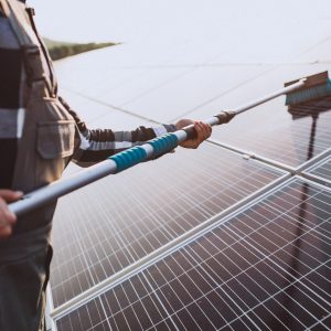 man worker in the firld by the solar panels